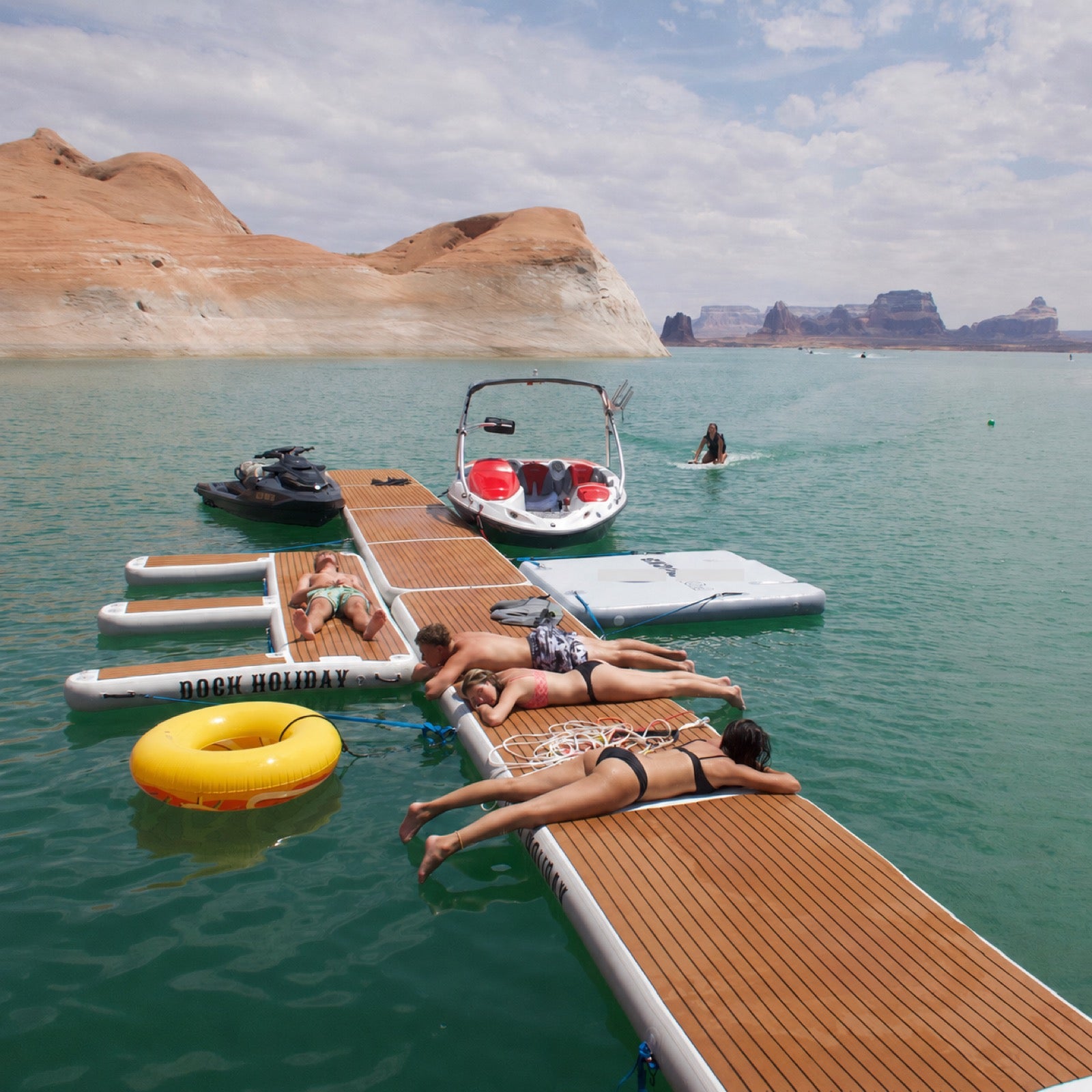 Friends sunbathing on a Dock Holiday platform at Lake Powell